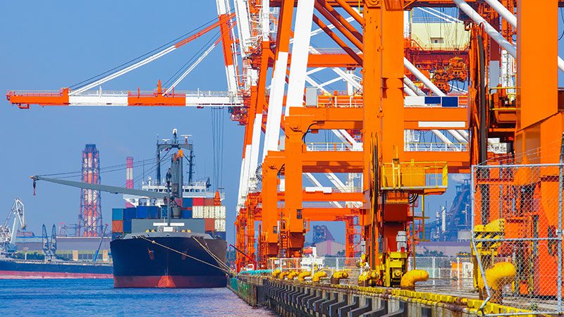 ship with containers tethered to shipping port