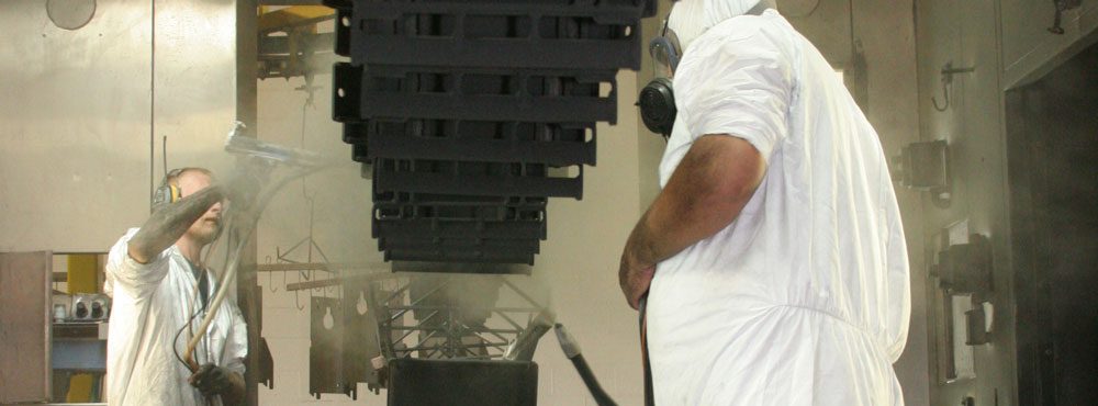 Workers working on a spray coating line.