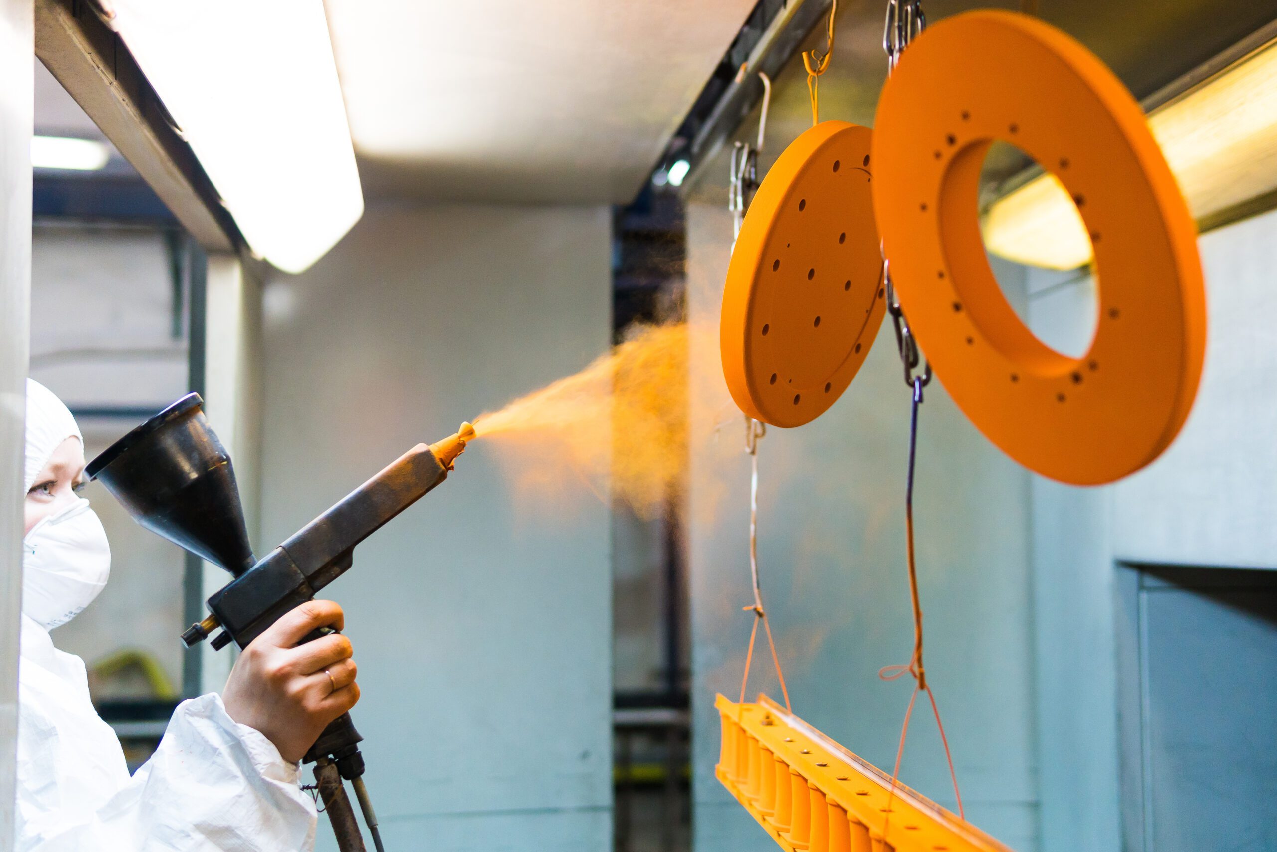 Metal parts being nylon powder coated.