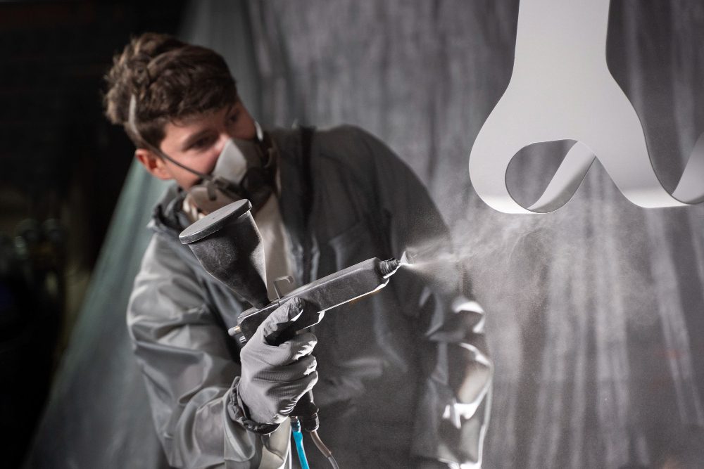 A man spraying epoxy coating.