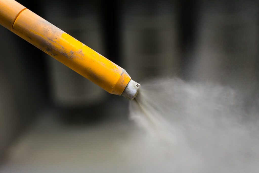 A yellow powder coated gun tip.