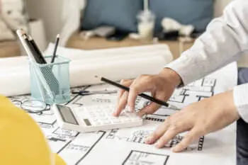 A person drawing a blueprint.